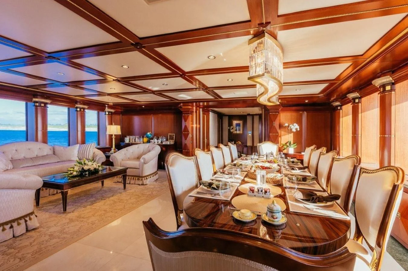 a large room with a table and chairs aboard STARSHIP Yacht for Charter