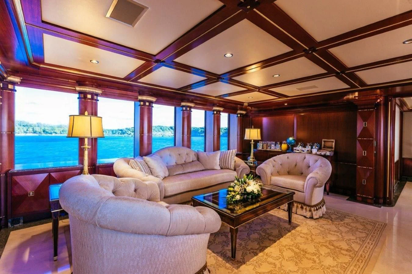 a living room with a large window aboard STARSHIP Yacht for Charter
