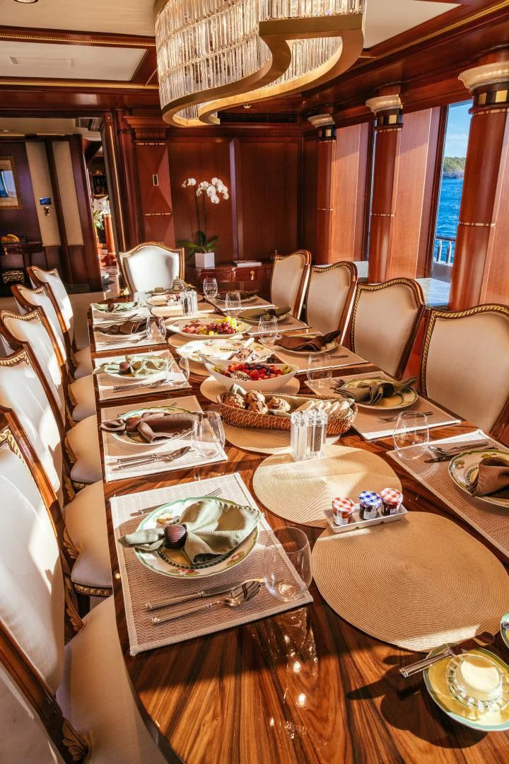 a table with plates and dishes on it aboard STARSHIP Yacht for Charter
