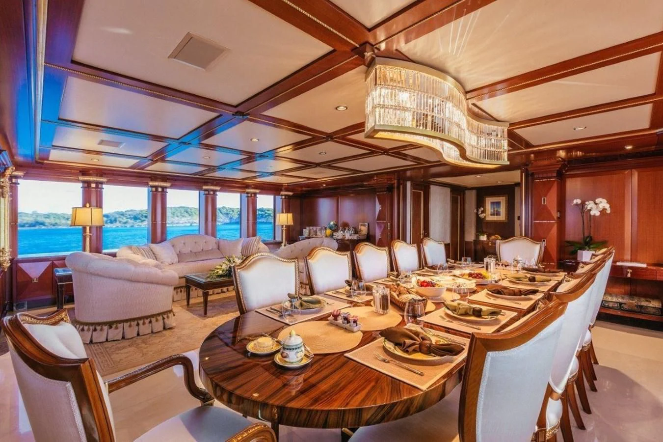 a large room with a table and chairs aboard STARSHIP Yacht for Charter