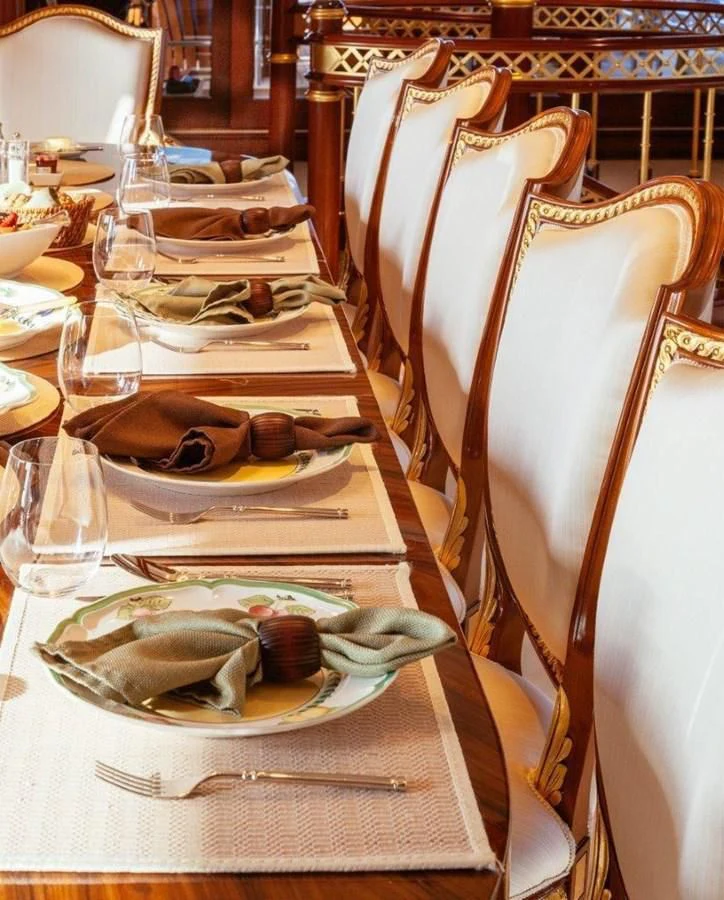 a table with plates and food on it aboard STARSHIP Yacht for Charter