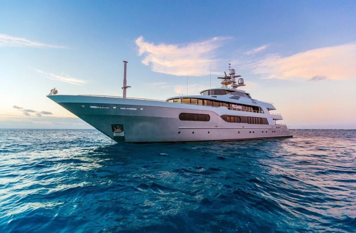 a large white ship in the water aboard STARSHIP Yacht for Charter