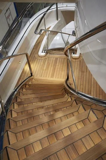 a staircase with a spiral staircase aboard LUNASEA Yacht for Sale