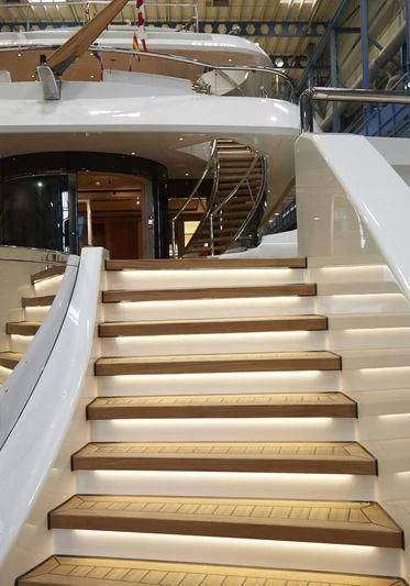 a white staircase in a building aboard LUNASEA Yacht for Sale