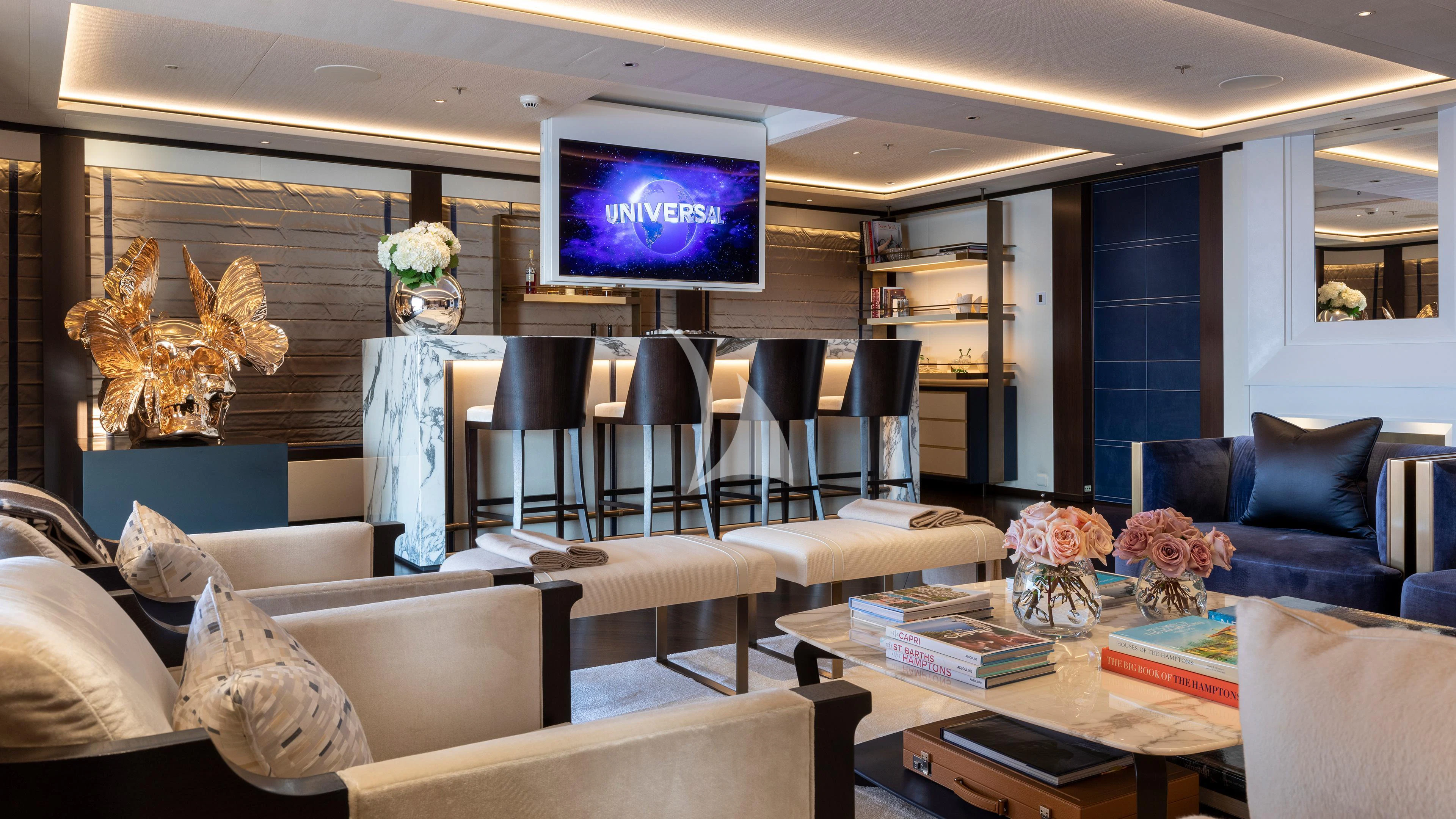 a room with a tv and couches aboard LUNASEA Yacht for Sale