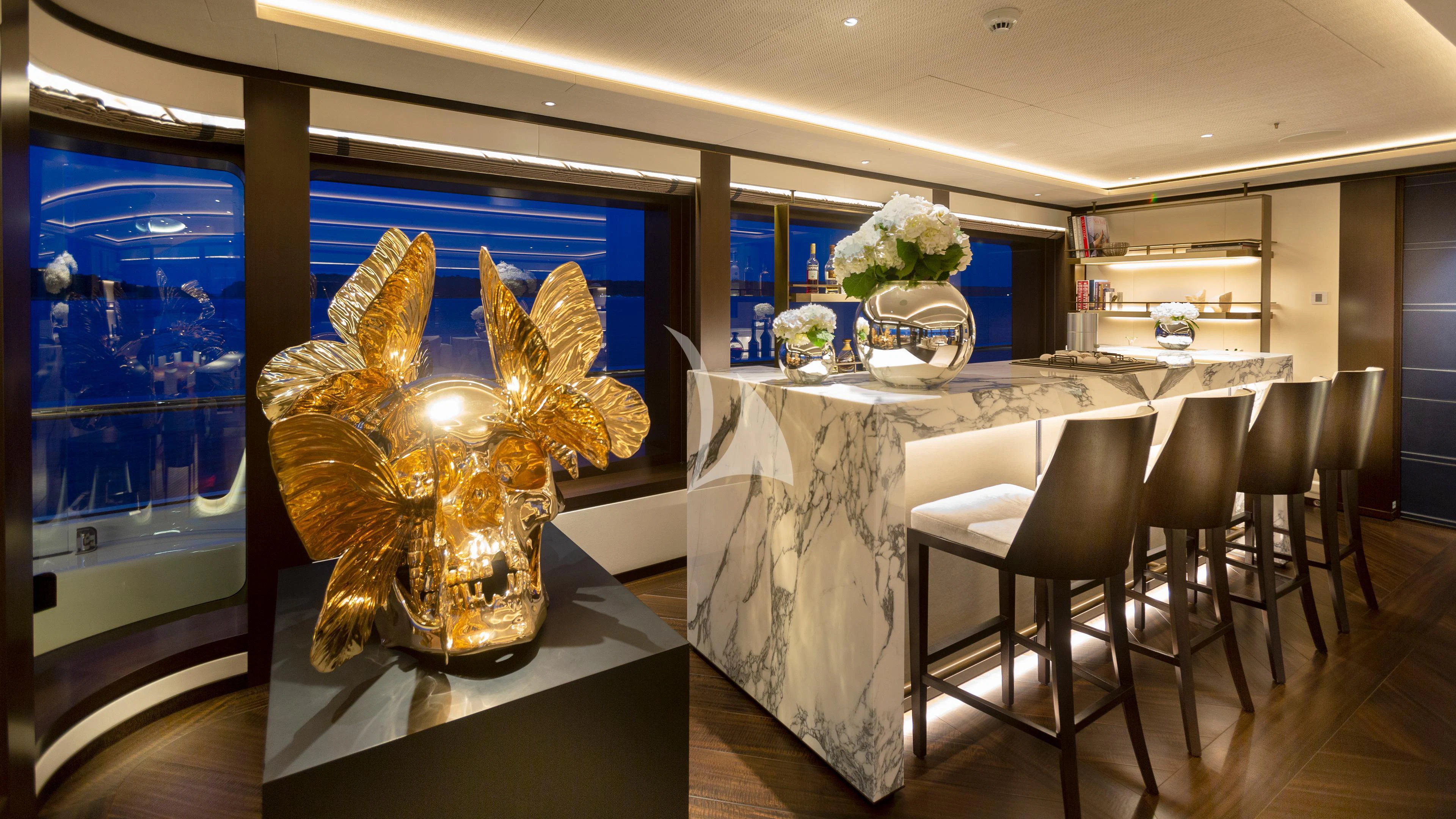 a large gold statue in a room aboard LUNASEA Yacht for Sale