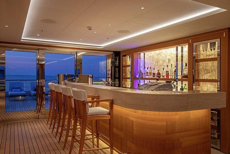 a room with tables and chairs aboard LUNASEA Yacht for Sale