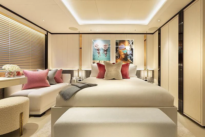 a large white bed with pink pillows aboard LUNASEA Yacht for Sale