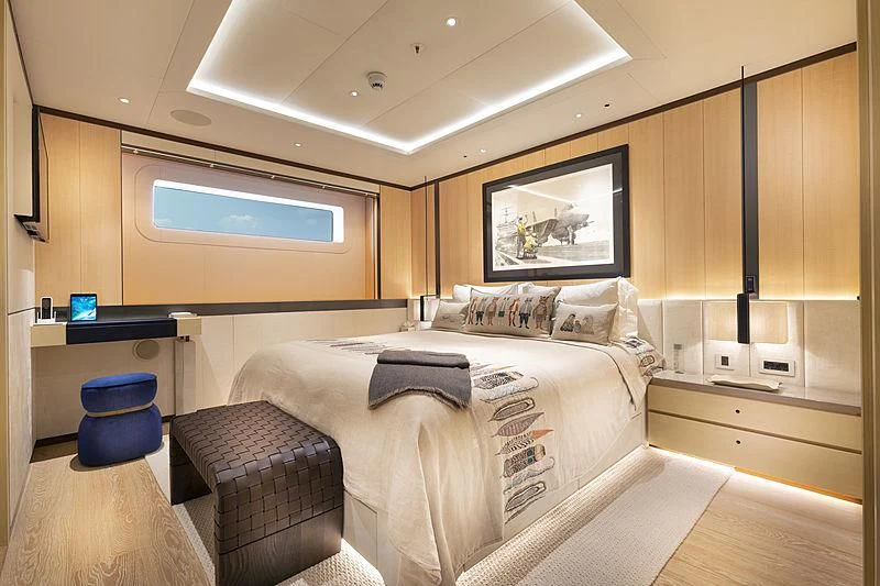 a bedroom with a bed and a desk aboard LUNASEA Yacht for Sale