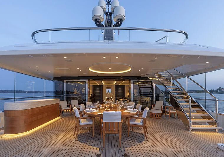 a large room with tables and chairs aboard LUNASEA Yacht for Sale
