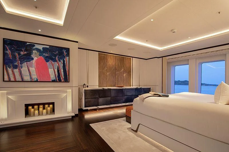 a room with a large bed and a large painting on the wall aboard LUNASEA Yacht for Sale