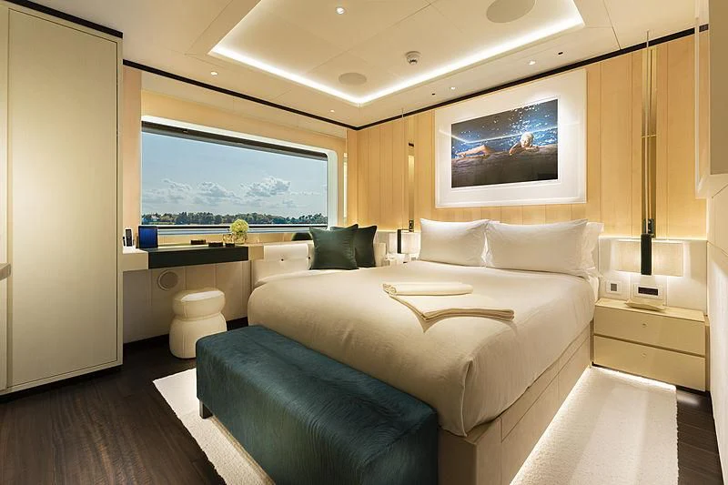 a bedroom with a bed and a desk aboard LUNASEA Yacht for Sale