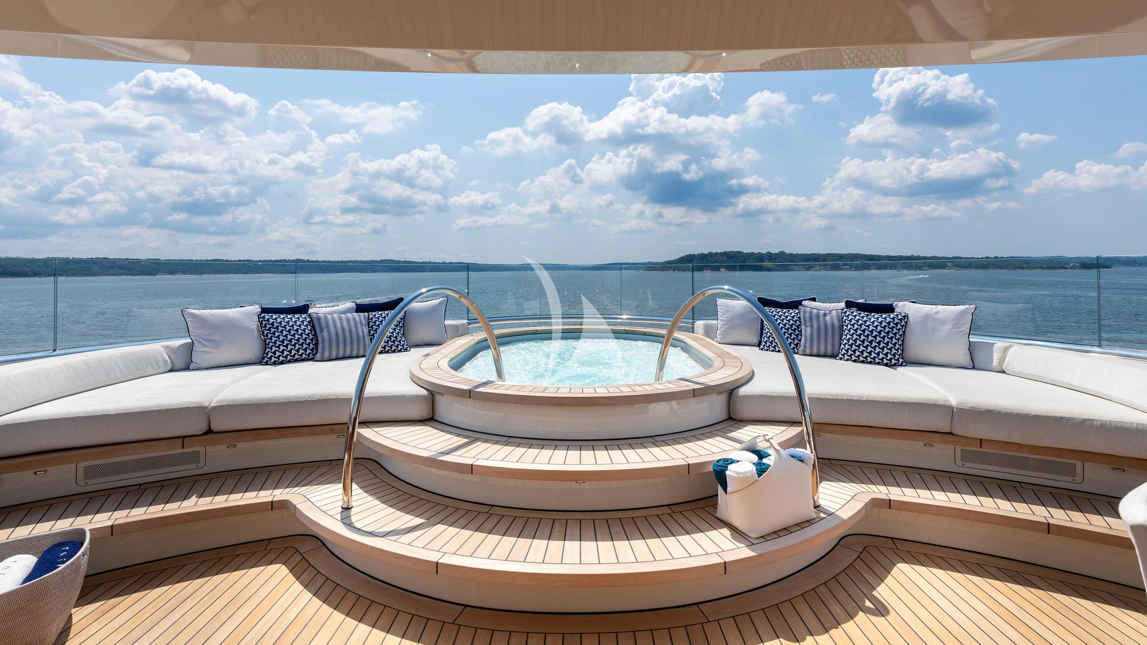 a large white tub on a deck overlooking a body of water aboard LUNASEA Yacht for Sale