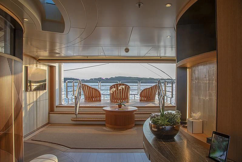 a room with a table and chairs aboard LUNASEA Yacht for Sale