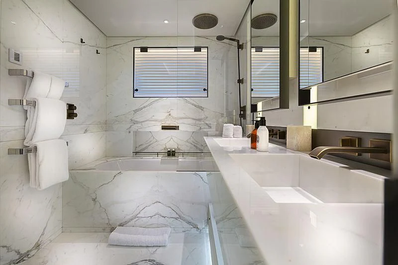 a bathroom with a tub sink and a window aboard LUNASEA Yacht for Sale