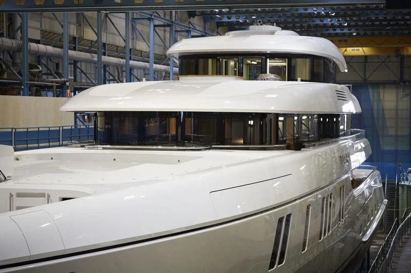 a white boat in a large warehouse aboard LUNASEA Yacht for Sale