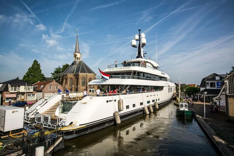 a large white boat docked at a dock aboard LUNASEA Yacht for Sale