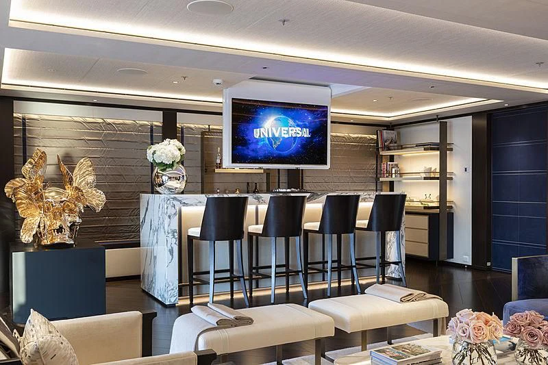 a room with a tv and chairs aboard LUNASEA Yacht for Sale