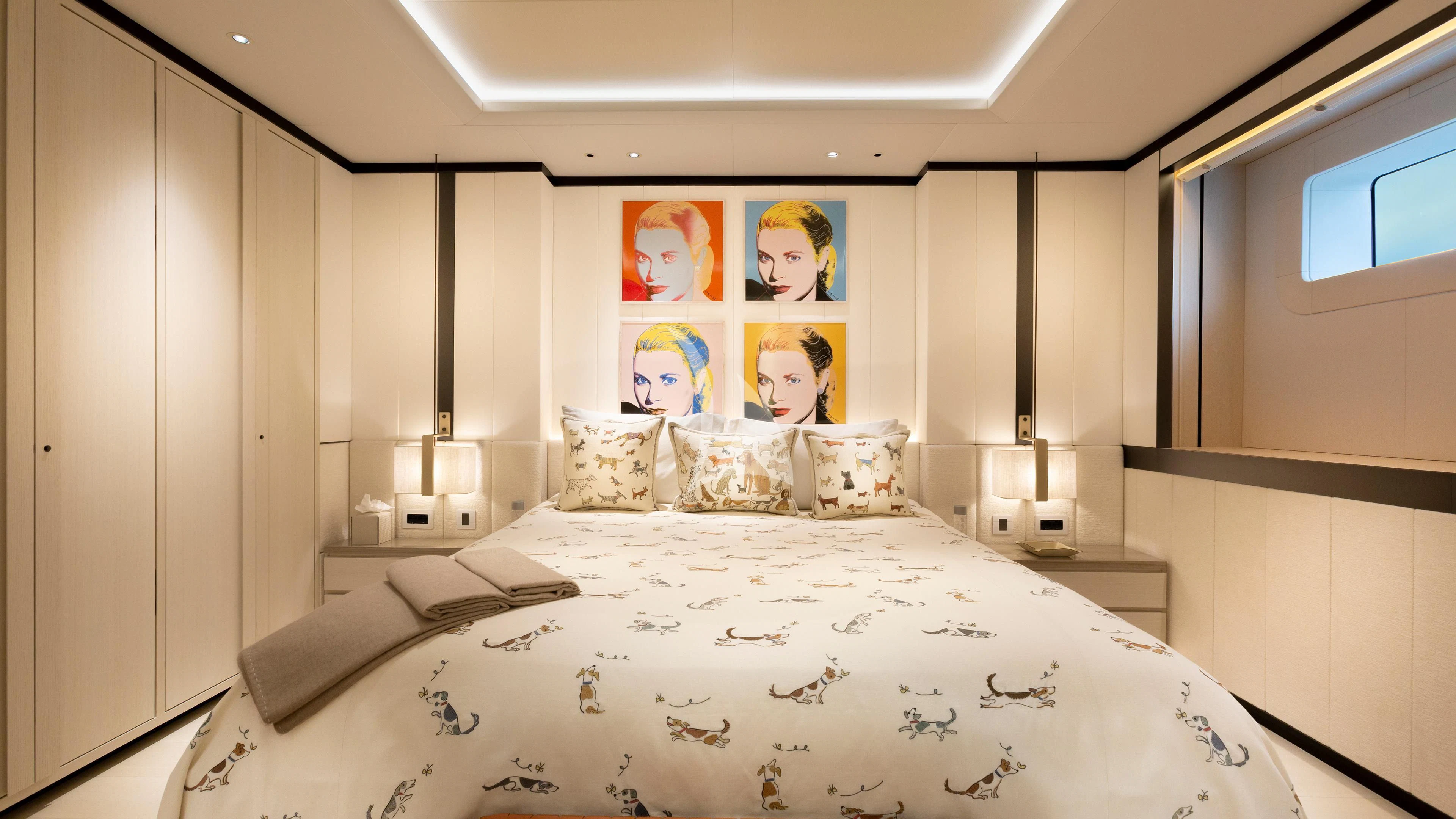 a bed with a white sheet and pillows aboard LUNASEA Yacht for Sale