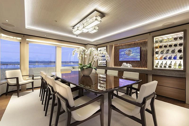 a room with tables and chairs aboard LUNASEA Yacht for Sale