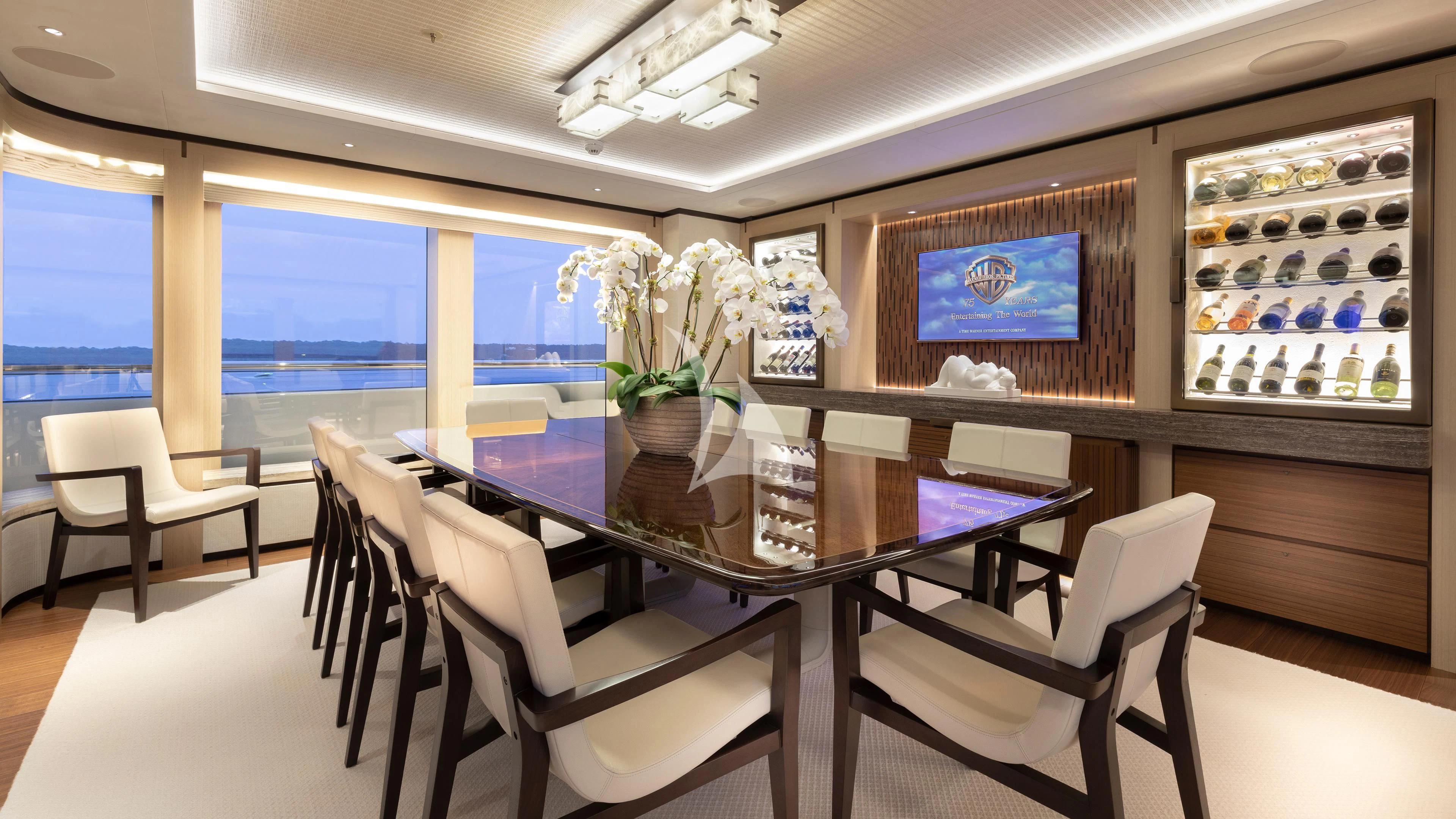 a room with tables and chairs aboard LUNASEA Yacht for Sale
