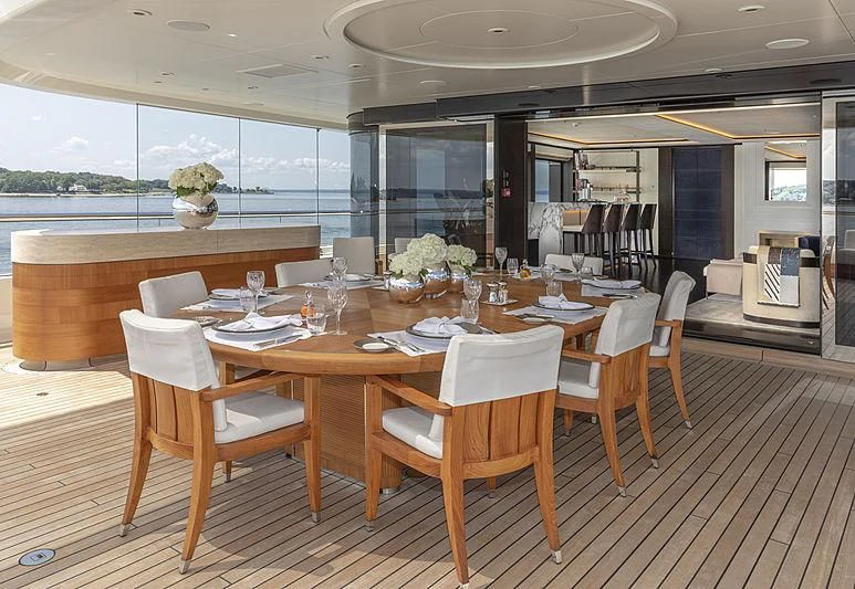 a dining table with chairs aboard LUNASEA Yacht for Sale
