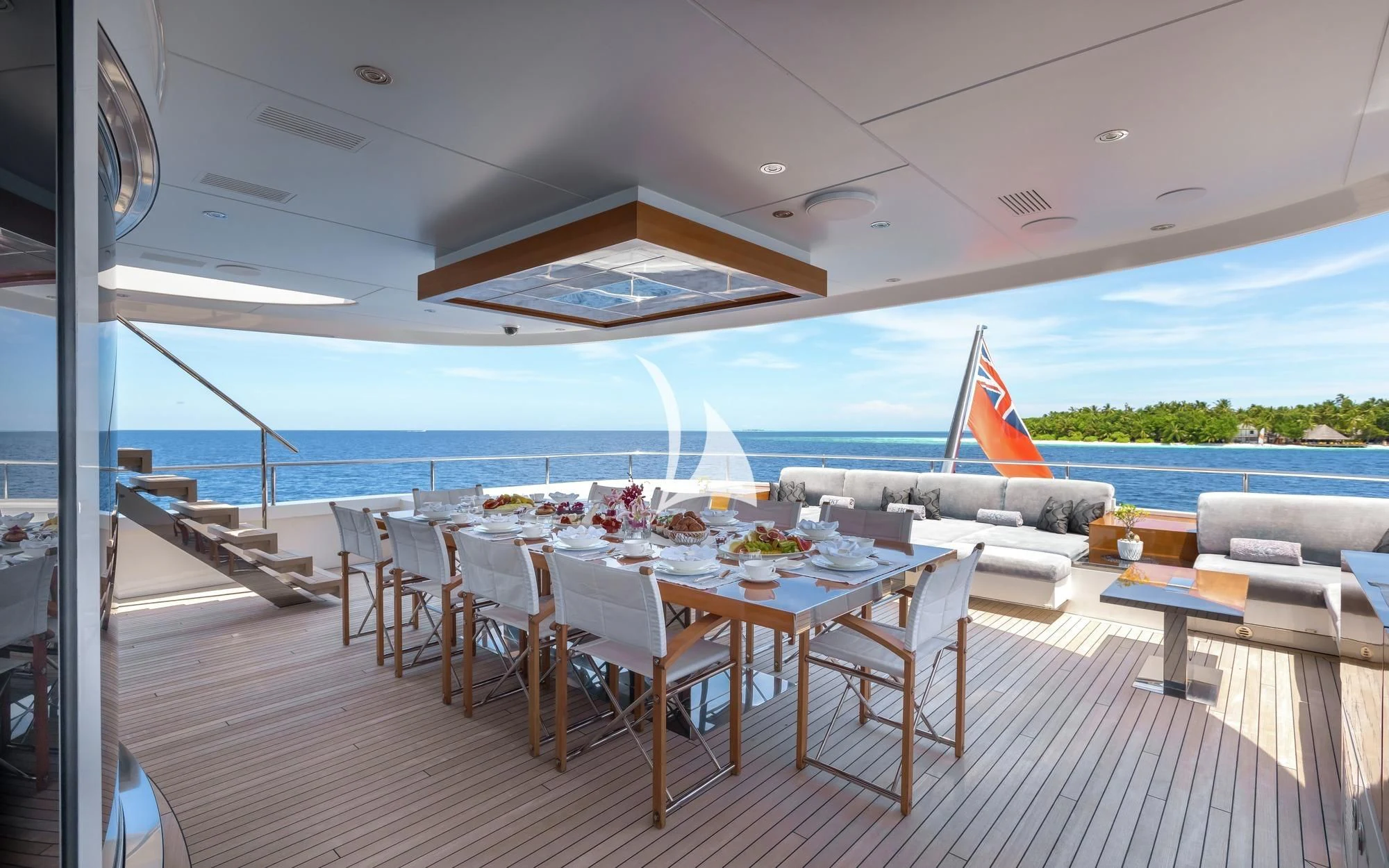 a room with tables and chairs aboard TOTEM Yacht for Sale