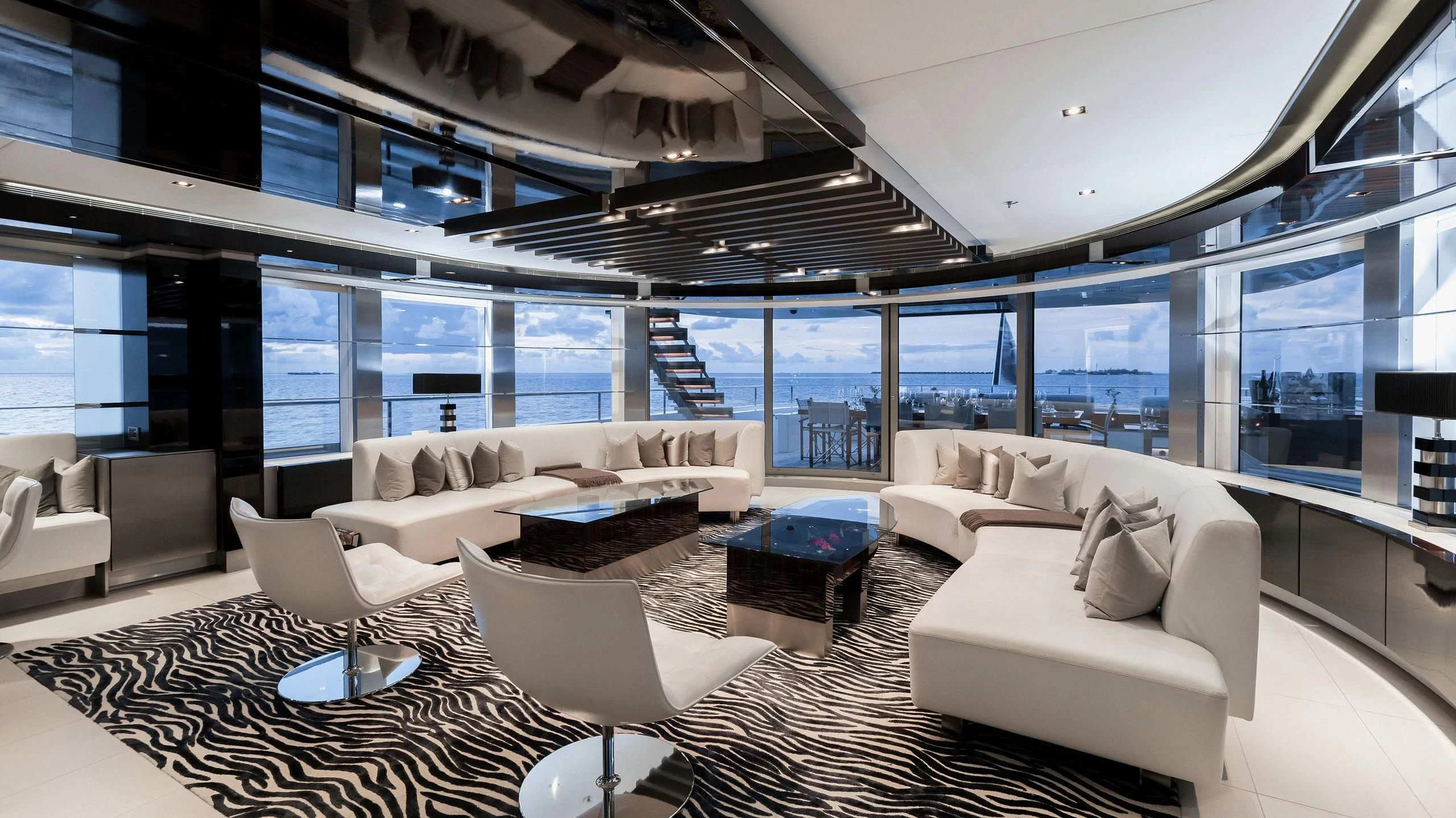 a large living room with white furniture aboard TOTEM Yacht for Sale