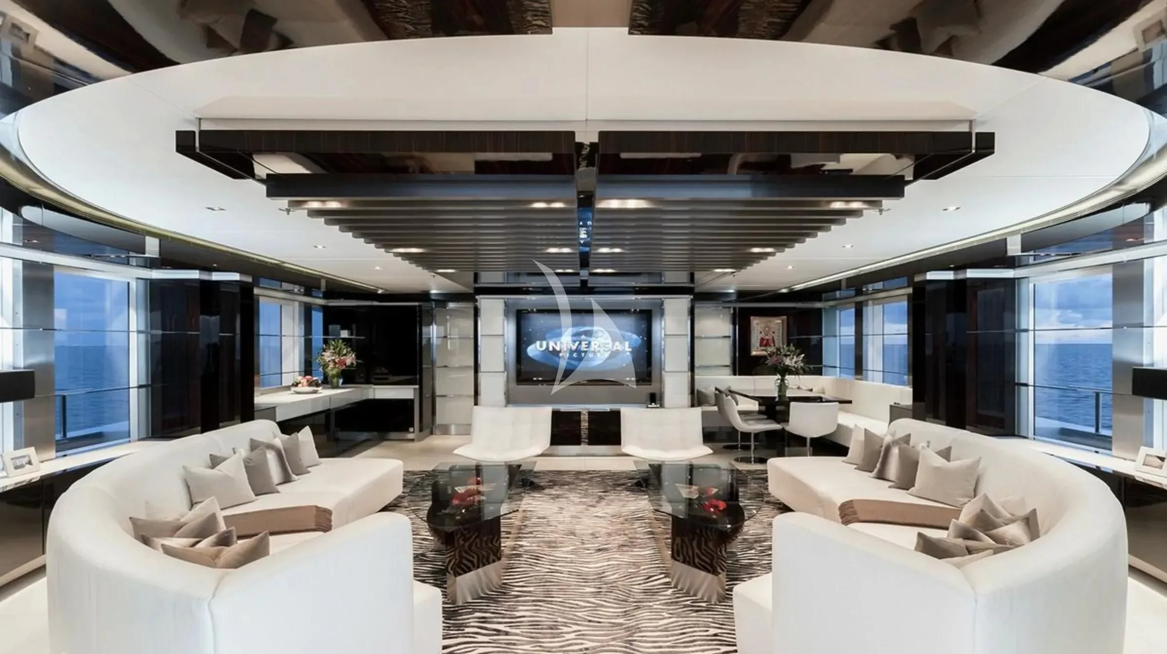 a room with a large white sofa and a large screen aboard TOTEM Yacht for Sale