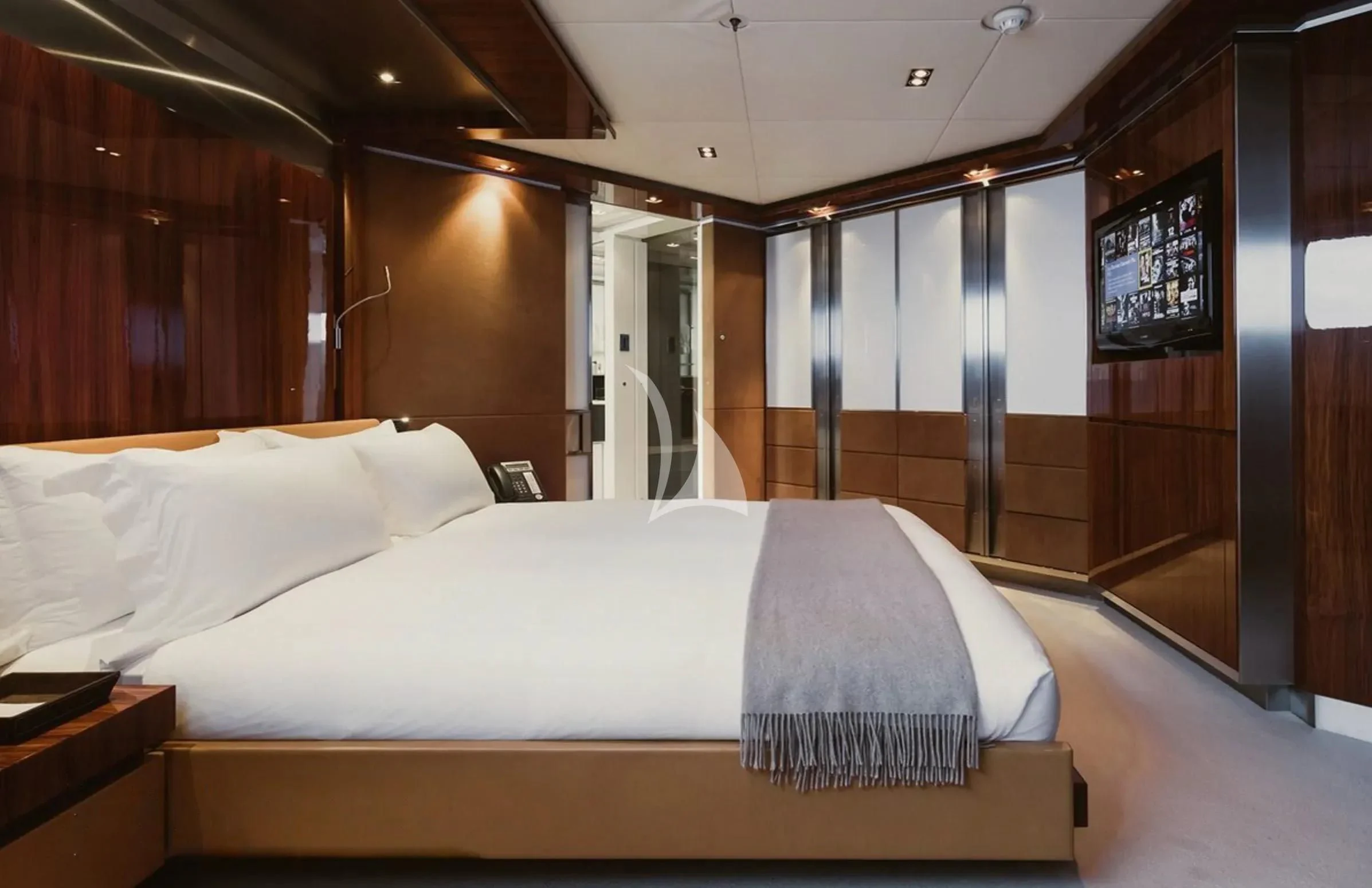 a room with a bed and a television aboard TOTEM Yacht for Sale