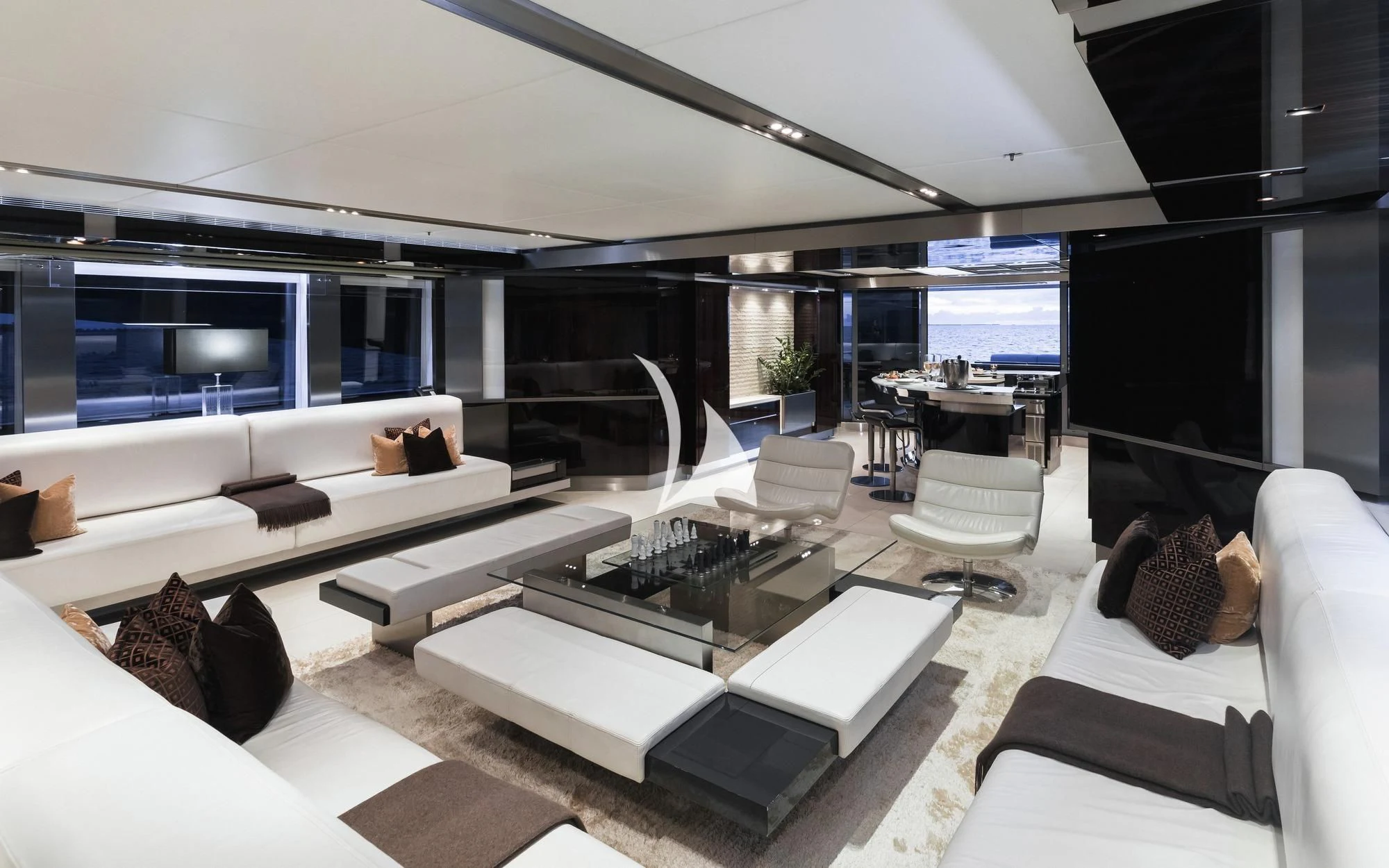 a room with a large white sofa and a large screen aboard TOTEM Yacht for Sale