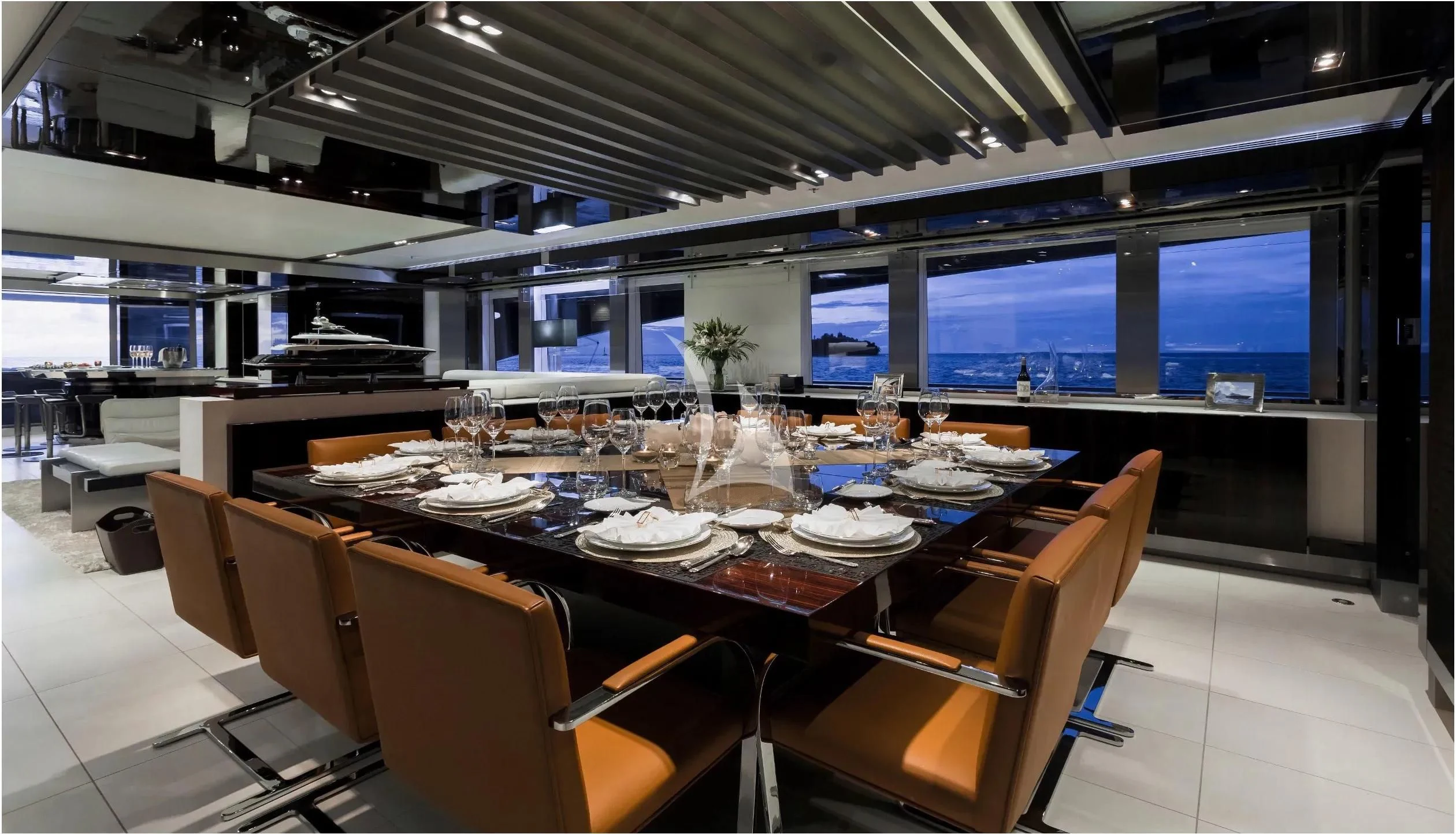 a large room with a table and chairs aboard TOTEM Yacht for Sale