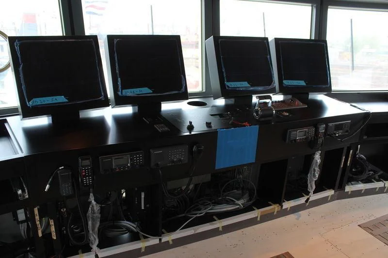 a group of computers on a table aboard GENESIA Yacht for Sale