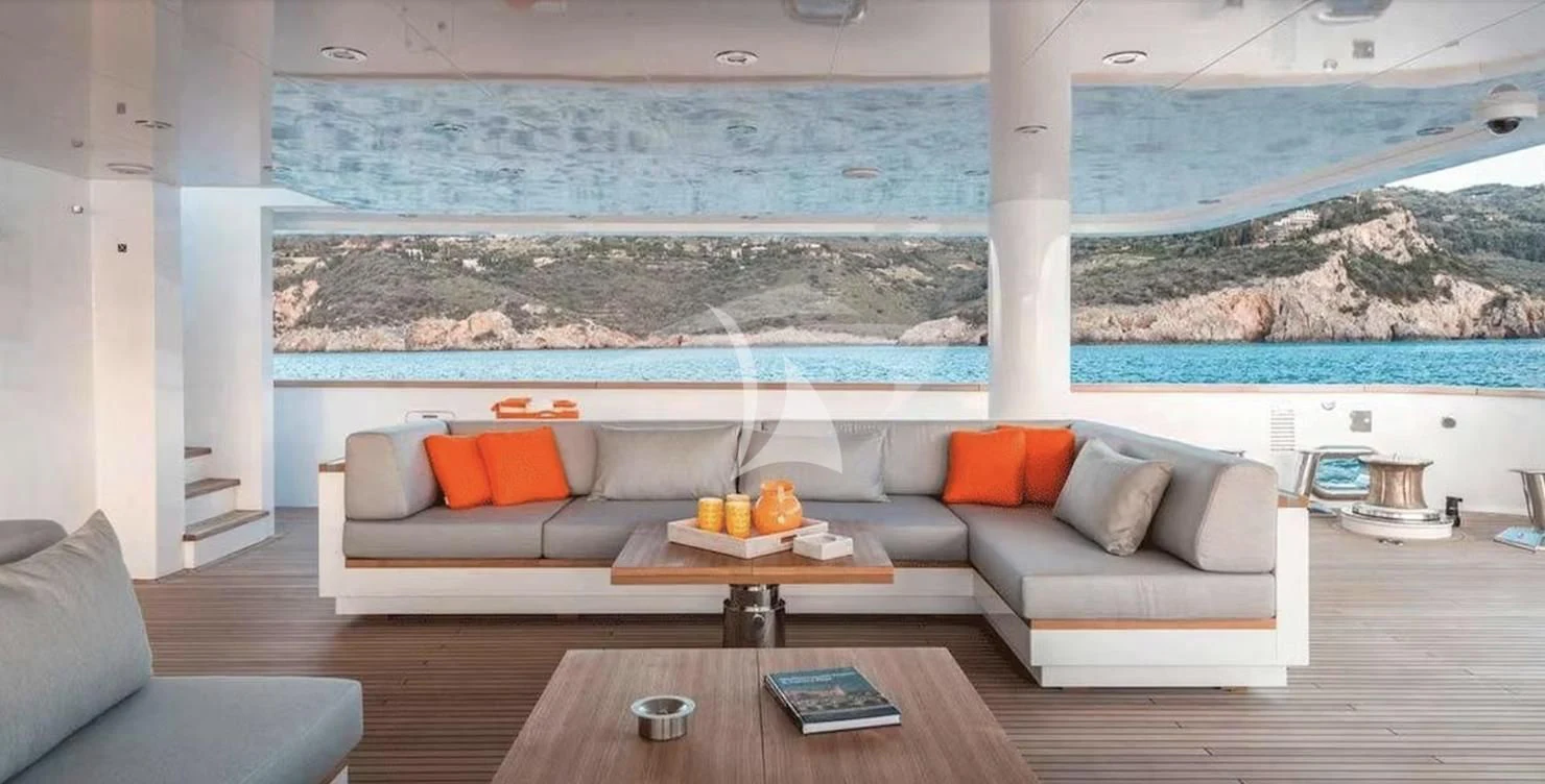 a living room with a couch and a table aboard GENESIA Yacht for Sale