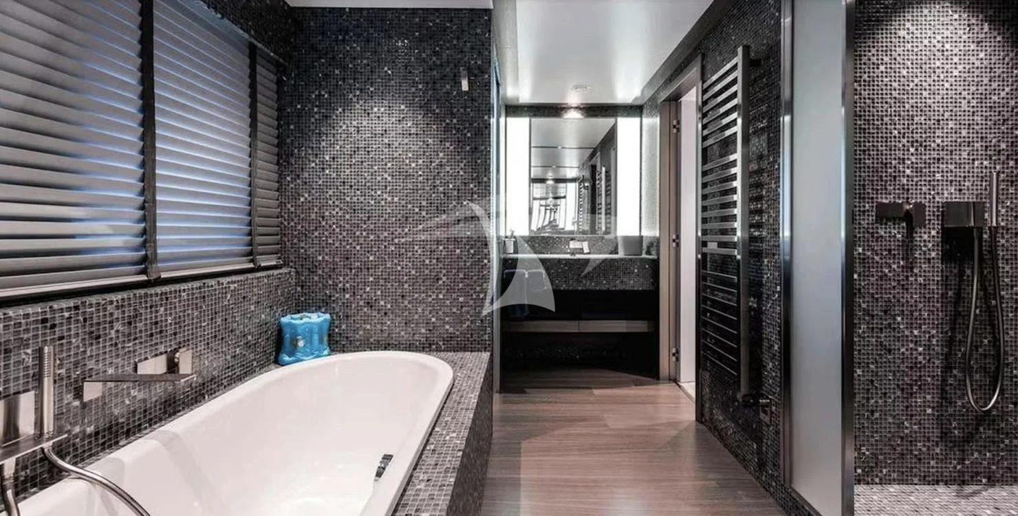 a bathroom with a tub and a sink aboard GENESIA Yacht for Sale