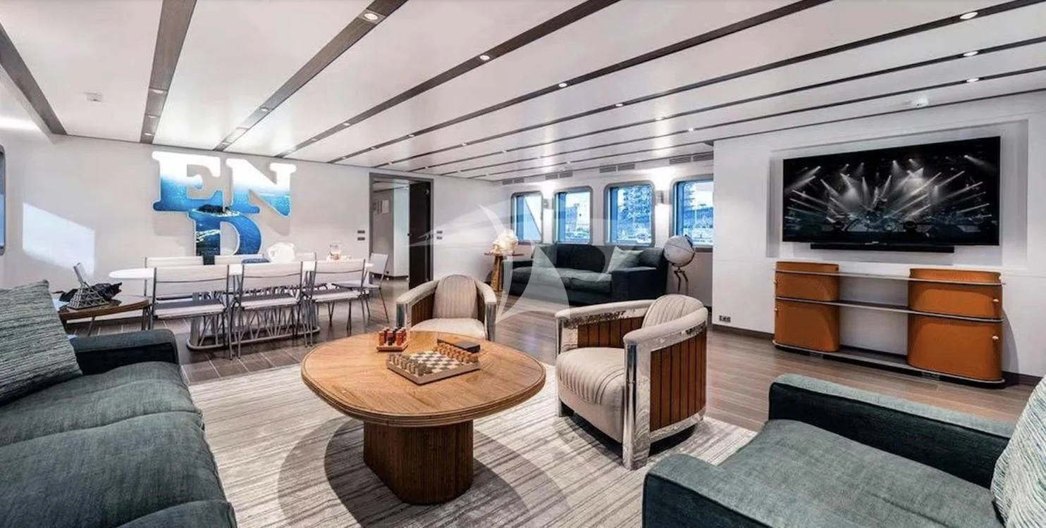 a living room with a large screen aboard GENESIA Yacht for Sale