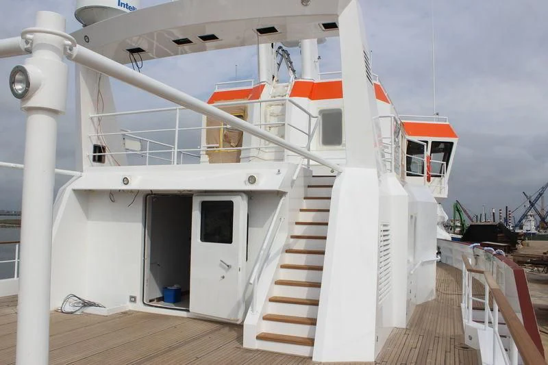a white boat on a deck aboard GENESIA Yacht for Sale