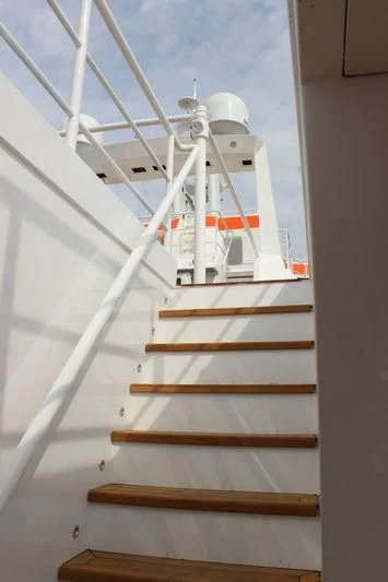 a white boat with a wooden frame aboard GENESIA Yacht for Sale