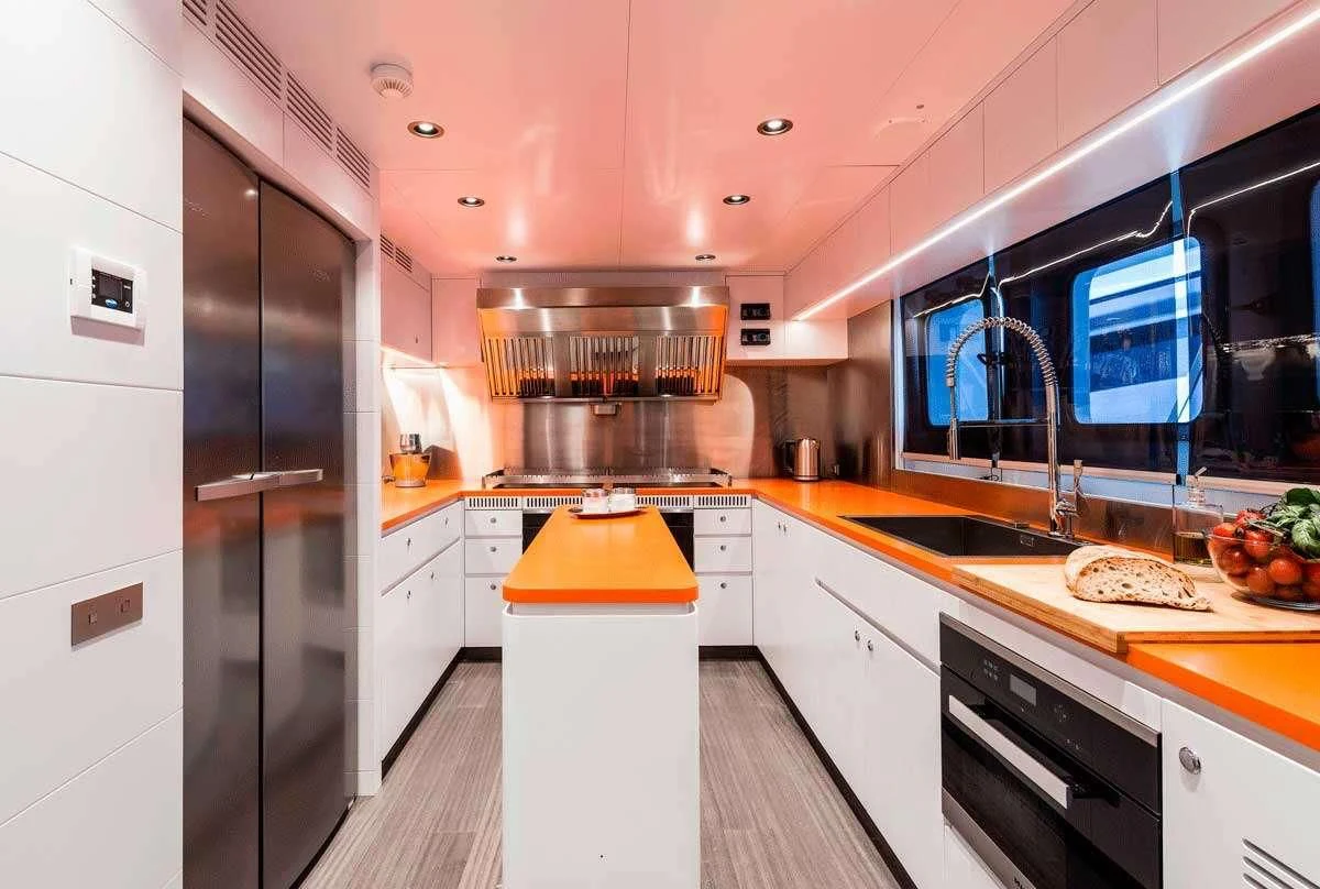 a kitchen with a refrigerator and a stove aboard GENESIA Yacht for Sale