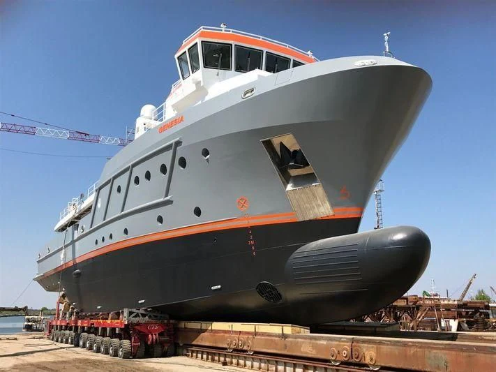 a large boat on a trailer aboard GENESIA Yacht for Sale