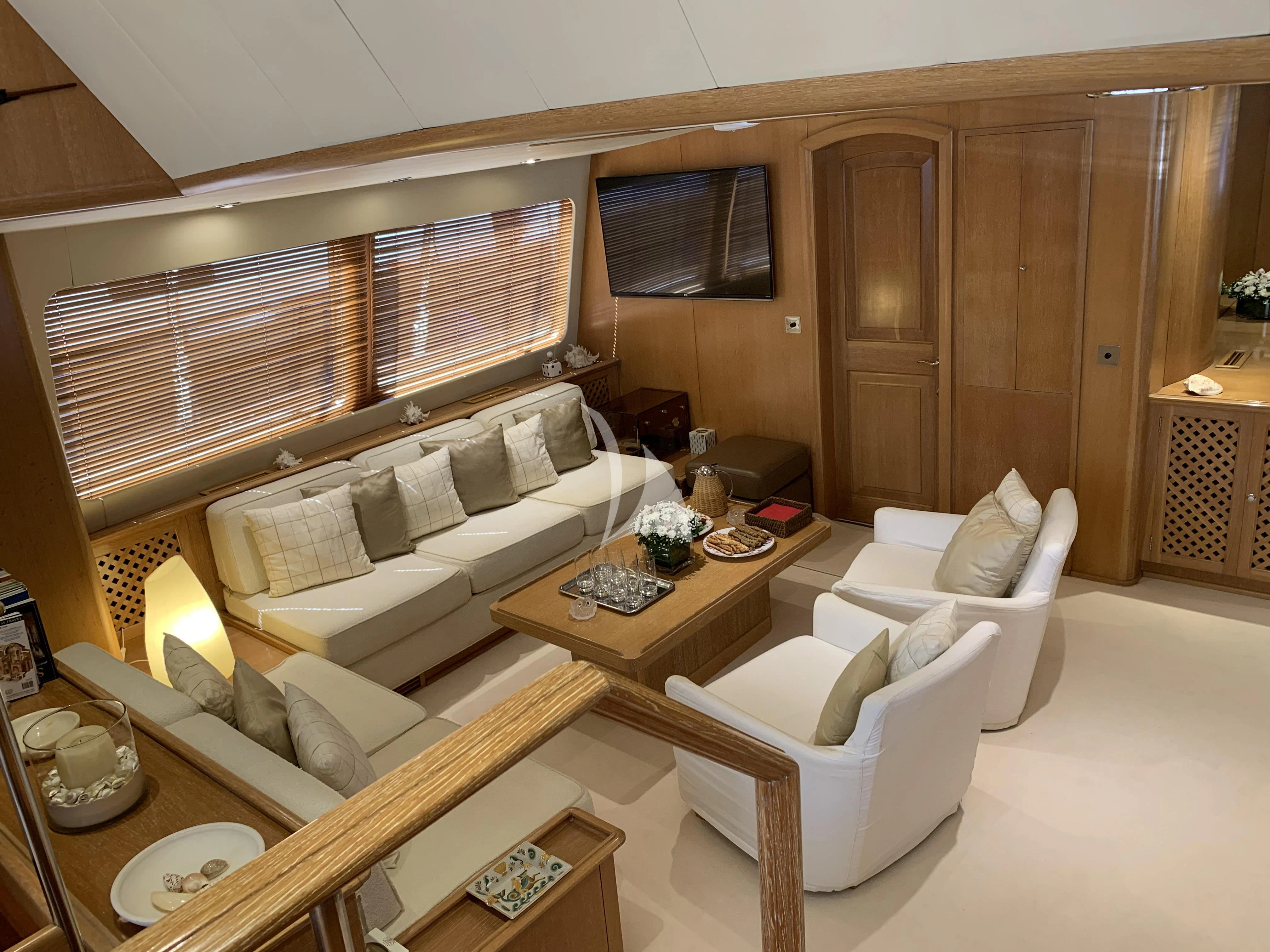 a living room with a couch and a table aboard ALTHEA Yacht for Sale