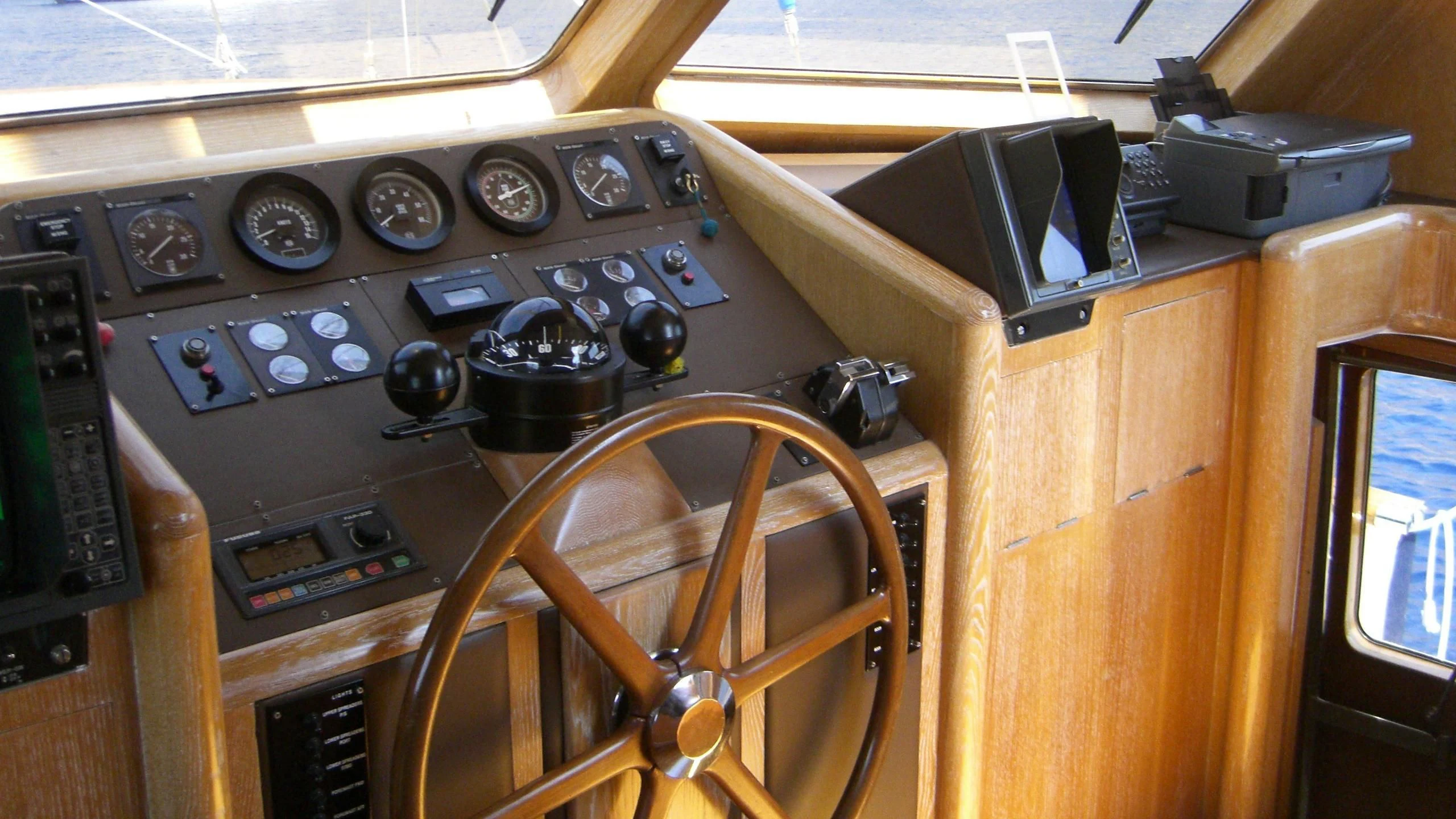 a wooden desk with a radio and radio aboard ALTHEA Yacht for Sale