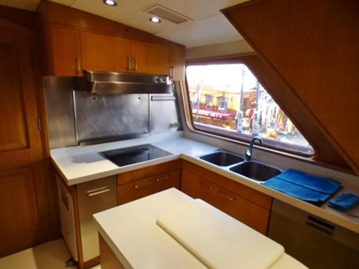 a kitchen with wooden cabinets aboard ALTHEA Yacht for Sale