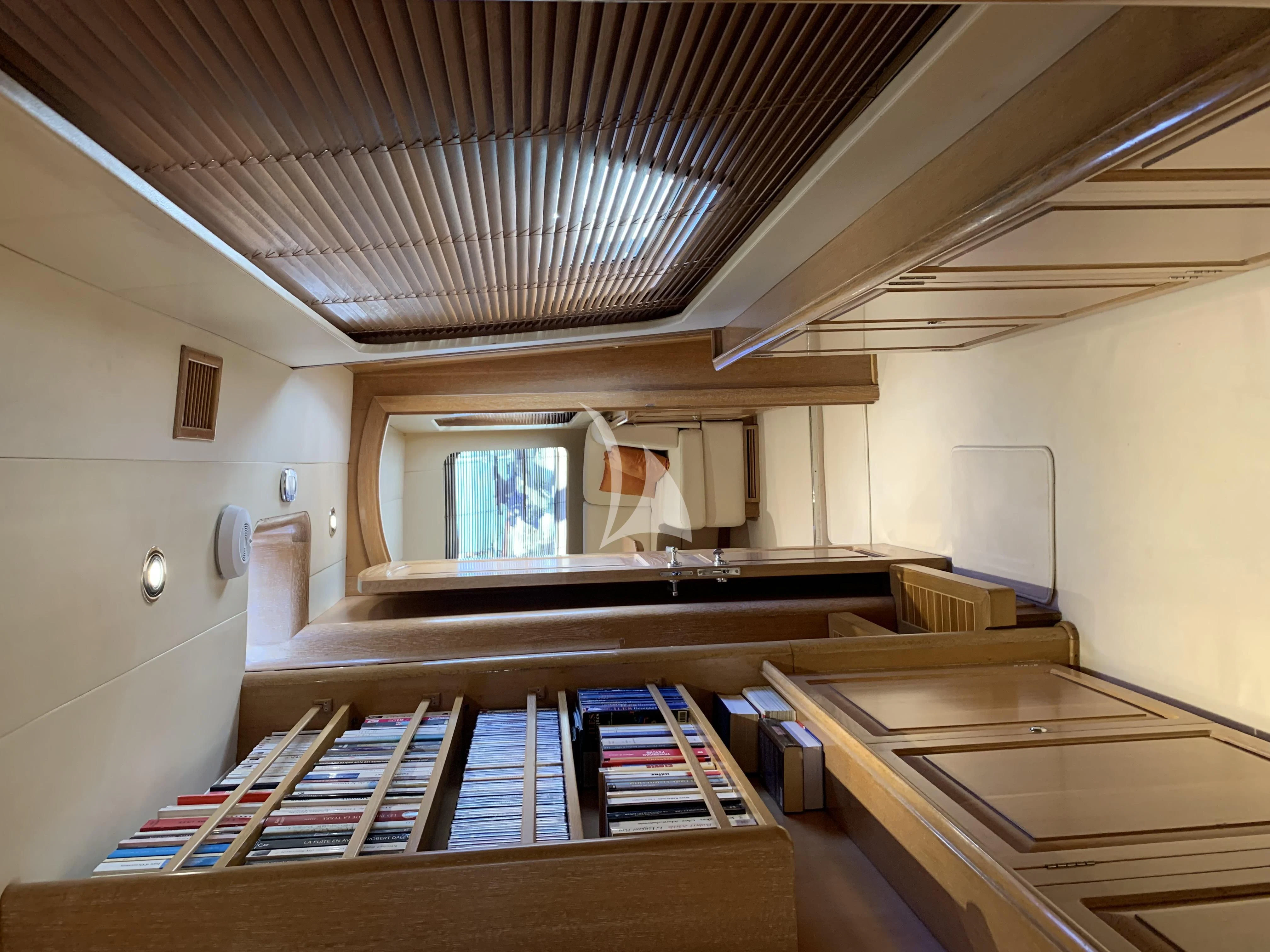 a room with a desk and a window aboard ALTHEA Yacht for Sale