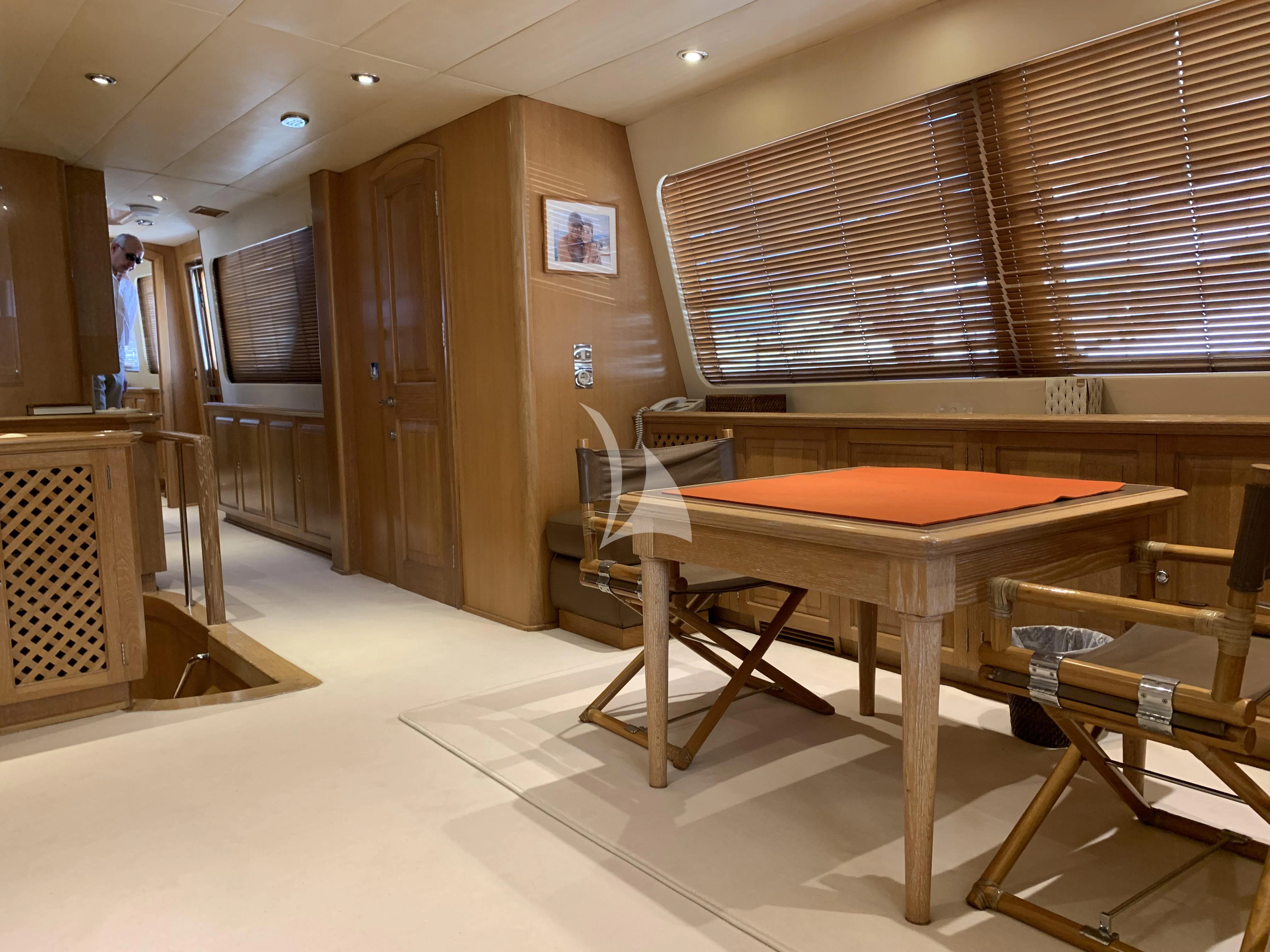 a room with a table and chairs aboard ALTHEA Yacht for Sale