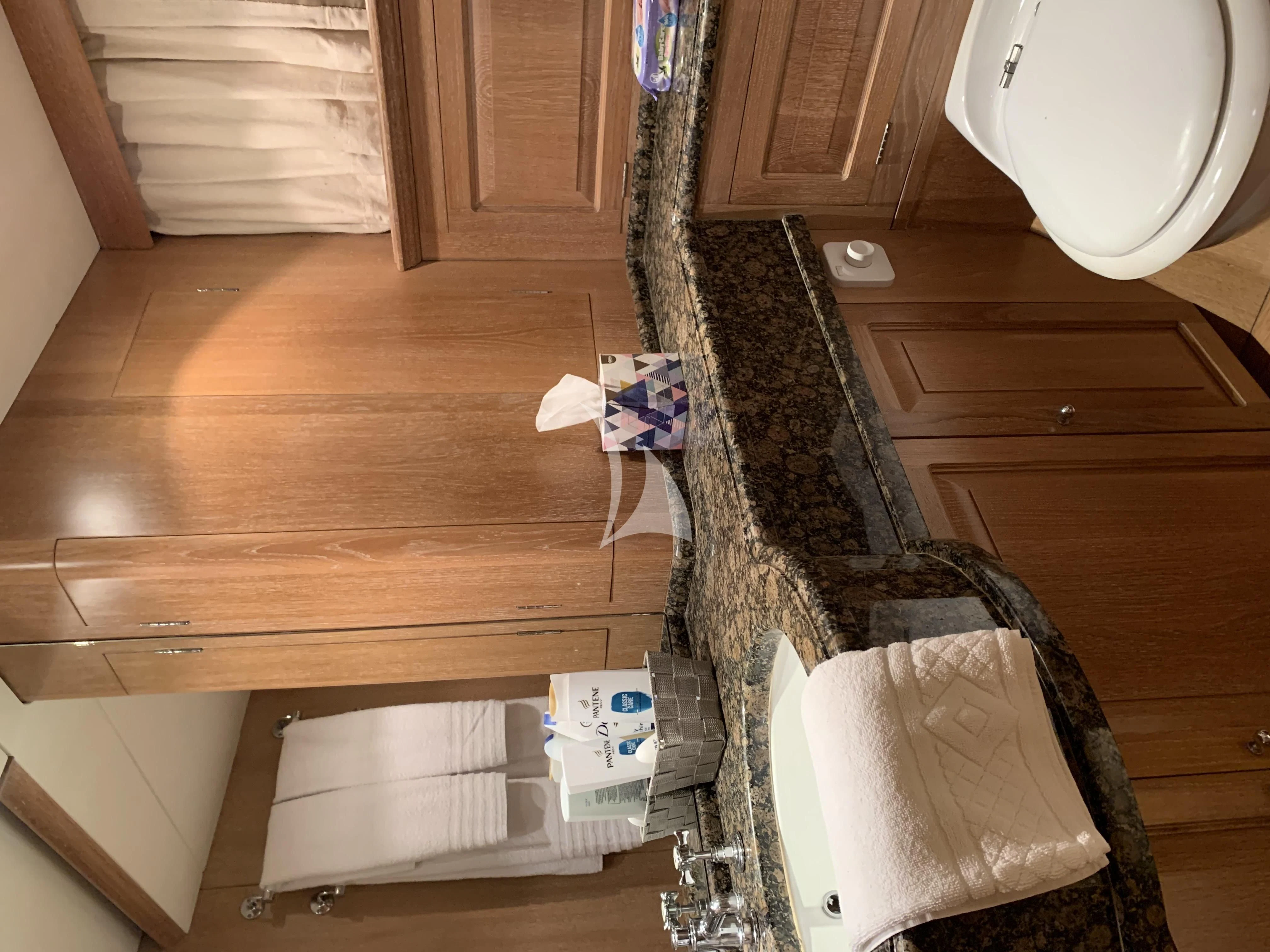 a bathroom with a toilet and a sink aboard ALTHEA Yacht for Sale