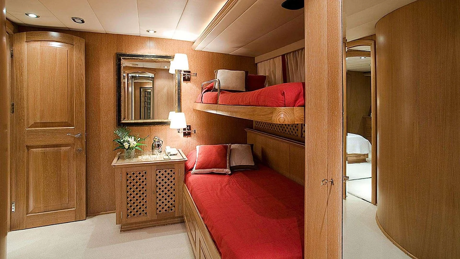a bedroom with a bed and a mirror aboard ALTHEA Yacht for Sale