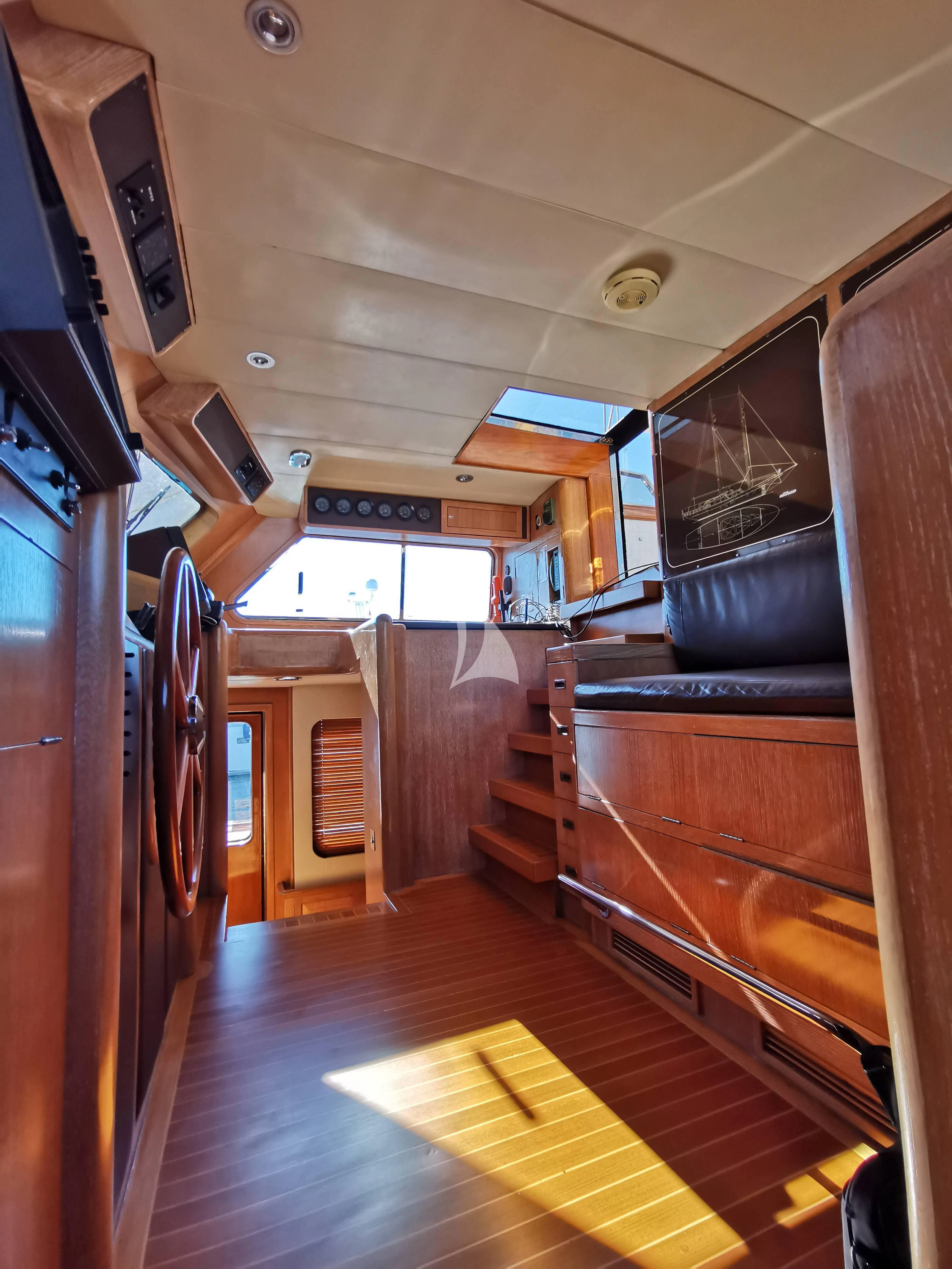 a room with a wood floor and a wood cabinet and a black chair aboard ALTHEA Yacht for Sale