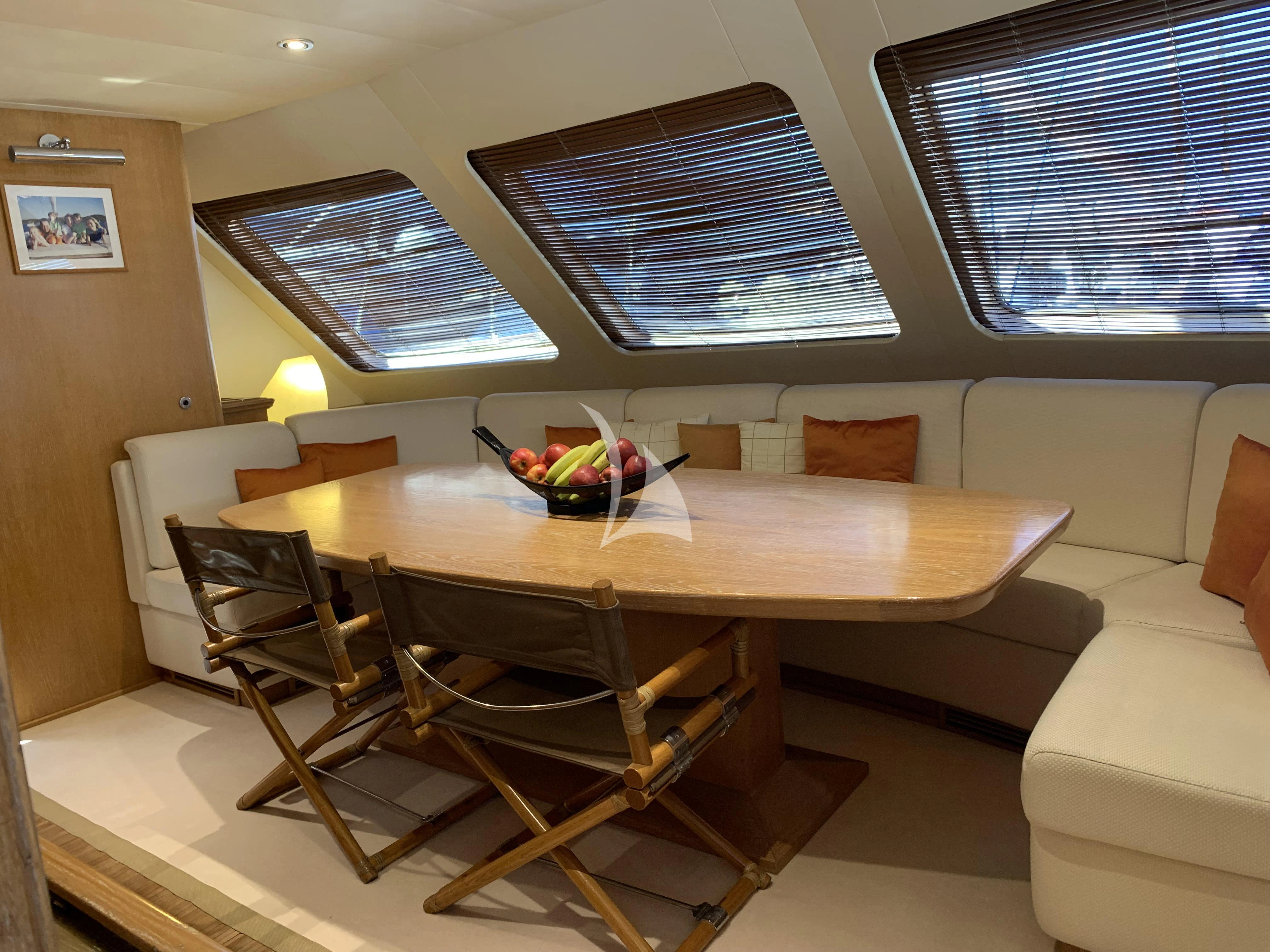 a room with a table and chairs aboard ALTHEA Yacht for Sale