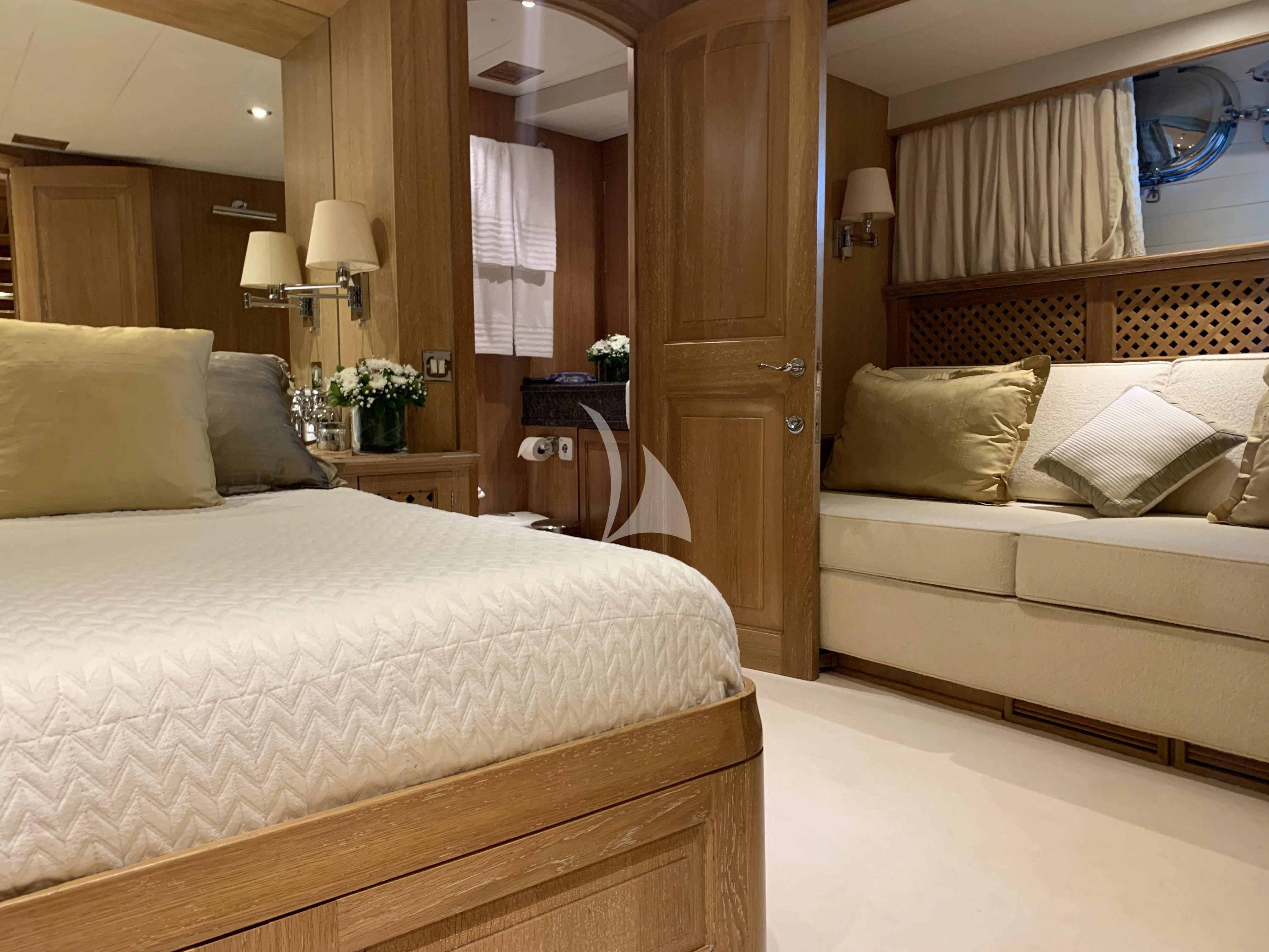 a bedroom with a bed and a door aboard ALTHEA Yacht for Sale